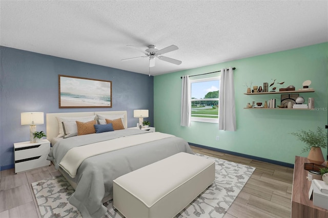 800 Black Duck Dr, Port Orange, FL 32127 - bedroom featuring a textured ceiling, light wood-style flooring, and a ceiling fan