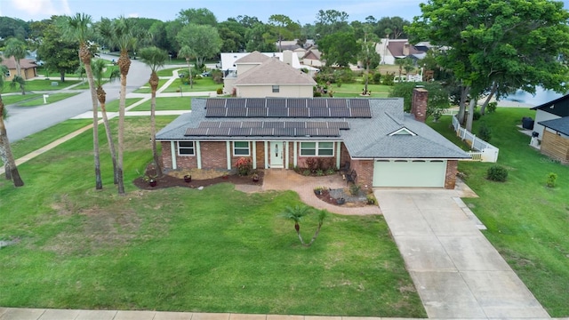 800 Black Duck Dr, Port Orange, FL 32127 - view of front facade featuring brick siding, driveway, roof mounted solar panels, and a front lawn