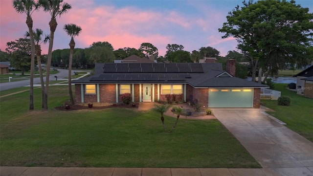 800 Black Duck Dr, Port Orange, FL 32127 - ranch-style house with an attached garage, brick siding, a front yard, concrete driveway, and solar panels