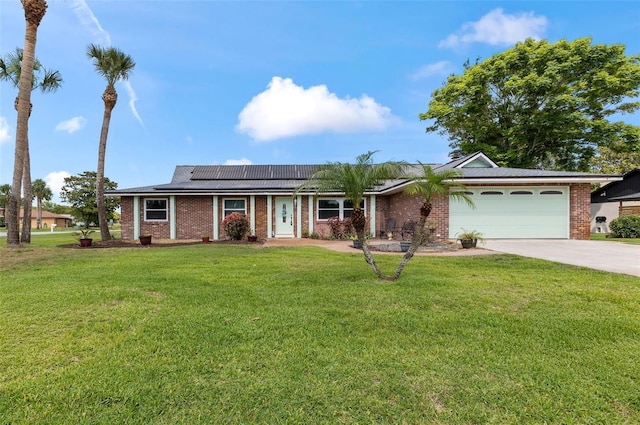 800 Black Duck Dr, Port Orange, FL 32127 - ranch-style house with a garage, driveway, brick siding, and roof mounted solar panels