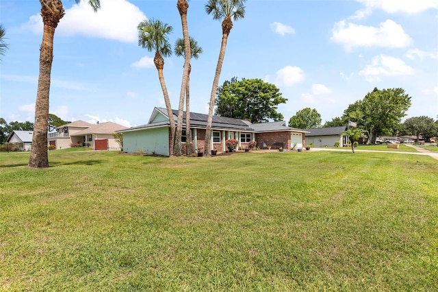 800 Black Duck Dr, Port Orange, FL 32127 - view of front of home with roof mounted solar panels, a front yard, and a garage