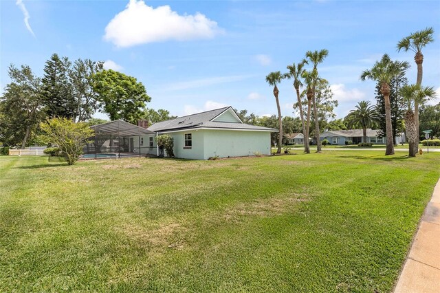 800 Black Duck Dr, Port Orange, FL 32127 - view of green lawn with glass enclosure, a carport, and an outdoor pool