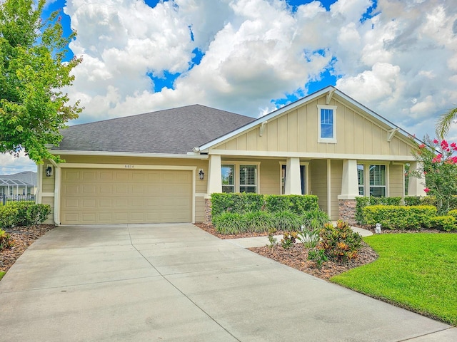 6804 Forkmead Ln, Port Orange, FL 32128 - craftsman-style home featuring board and batten siding, an attached garage, concrete driveway, a shingled roof, and a front yard