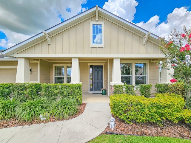 6804 Forkmead Ln, Port Orange, FL 32128 - view of front of home with board and batten siding, covered porch, and a garage