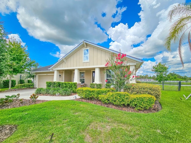 6804 Forkmead Ln, Port Orange, FL 32128 - view of front of property with board and batten siding, a garage, driveway, and covered porch