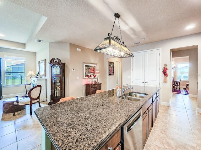 6804 Forkmead Ln, Port Orange, FL 32128 - kitchen with dishwasher, a textured ceiling, dark stone countertops, an island with sink, and hanging light fixtures