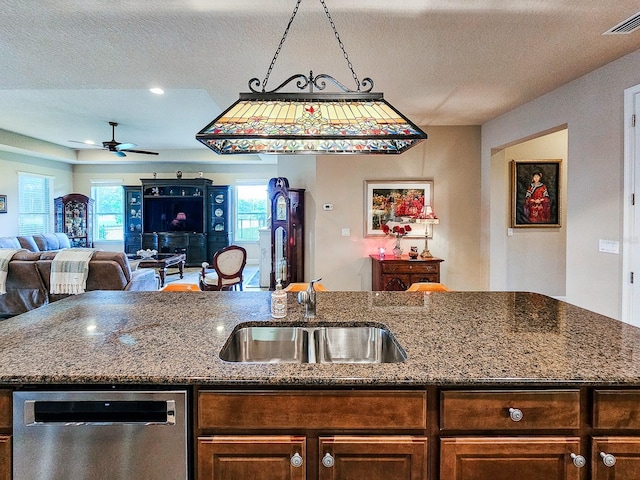 6804 Forkmead Ln, Port Orange, FL 32128 - kitchen featuring dishwasher, a textured ceiling, open floor plan, a ceiling fan, and dark stone countertops