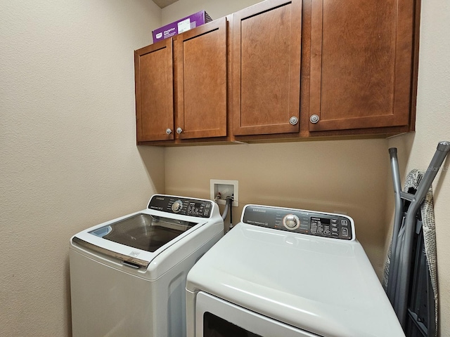 6804 Forkmead Ln, Port Orange, FL 32128 - laundry area with washer and dryer, cabinet space, and a textured wall