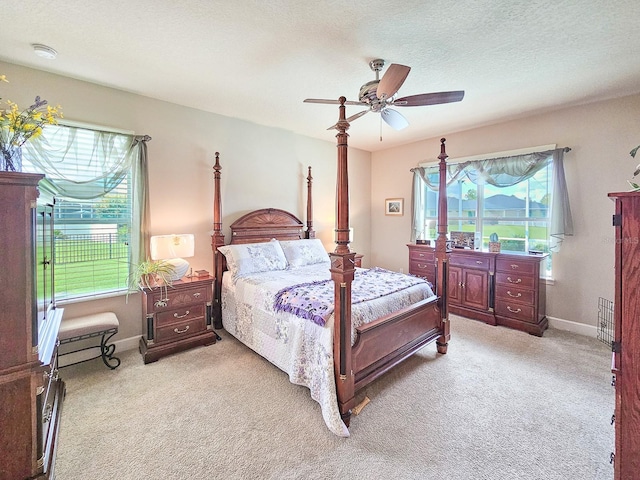 6804 Forkmead Ln, Port Orange, FL 32128 - bedroom with light carpet, a ceiling fan, and a textured ceiling