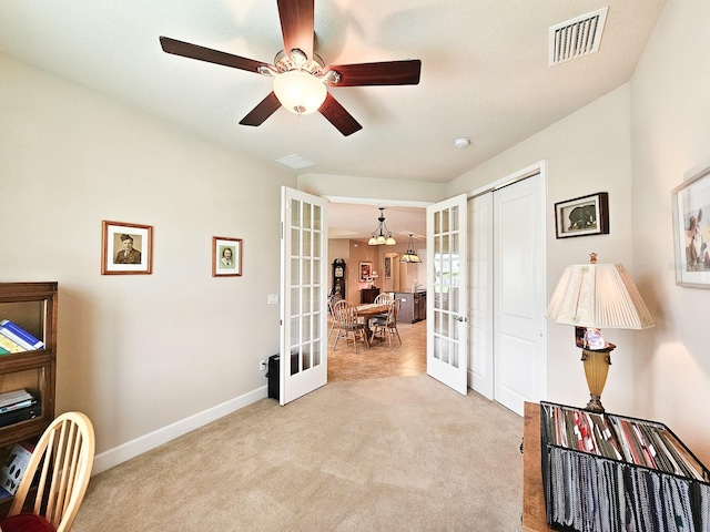 6804 Forkmead Ln, Port Orange, FL 32128 - office space with french doors, light colored carpet, a ceiling fan, and a chandelier