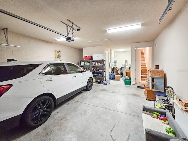 6804 Forkmead Ln, Port Orange, FL 32128 - garage featuring a garage door opener and concrete block wall