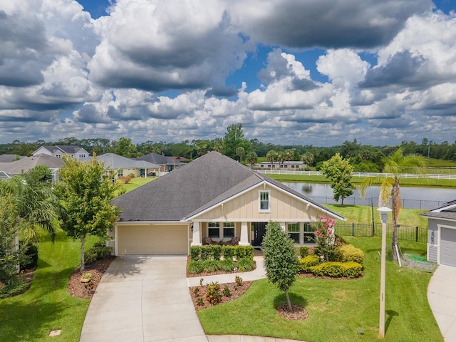 6804 Forkmead Ln, Port Orange, FL 32128 - view of front of property featuring an attached garage, driveway, a shingled roof, and a water view