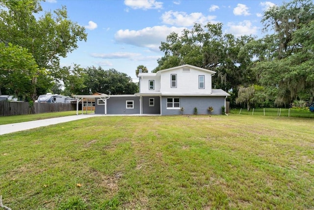 2005 Sunny Ln, New Smyrna Beach, FL 32168 - traditional home featuring concrete driveway, an attached carport, view of wooded area, and stucco siding
