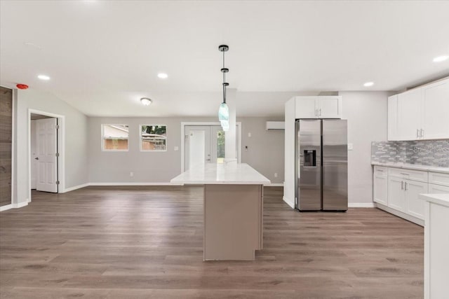 2005 Sunny Ln, New Smyrna Beach, FL 32168 - kitchen featuring stainless steel fridge with ice dispenser, white cabinets, decorative backsplash, light wood-type flooring, and recessed lighting