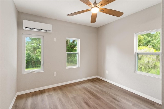 2005 Sunny Ln, New Smyrna Beach, FL 32168 - spare room with a wall unit AC, plenty of natural light, and light wood-style flooring