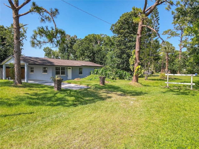 3045 Pine Tree Dr, Edgewater, FL 32141 - view of grassy yard with a patio area