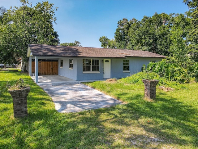 3045 Pine Tree Dr, Edgewater, FL 32141 - ranch-style home featuring a front lawn, stucco siding, driveway, and a carport