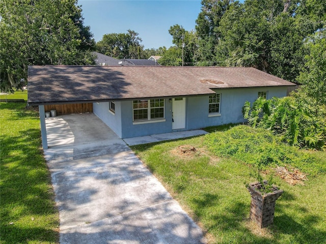 3045 Pine Tree Dr, Edgewater, FL 32141 - ranch-style home featuring concrete driveway, a front lawn, stucco siding, roof with shingles, and a carport
