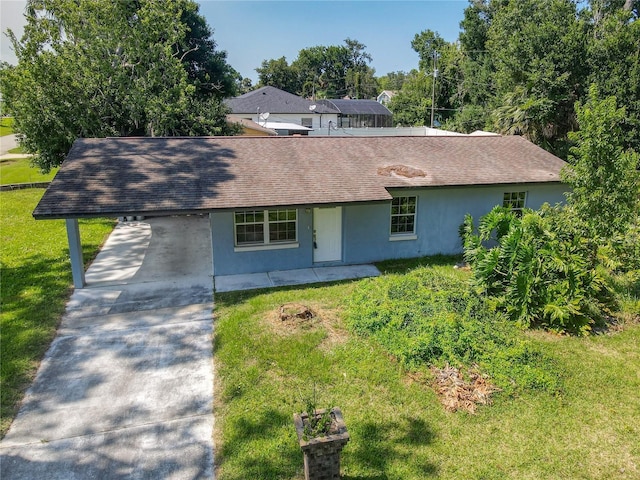 3045 Pine Tree Dr, Edgewater, FL 32141 - view of front facade featuring stucco siding, driveway, a front yard, roof with shingles, and a carport