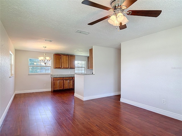 3045 Pine Tree Dr, Edgewater, FL 32141 - unfurnished living room with a chandelier, dark wood-style floors, a textured ceiling, and ceiling fan