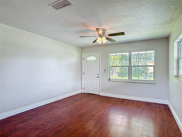 3045 Pine Tree Dr, Edgewater, FL 32141 - foyer entrance with a textured wall, a ceiling fan, wood finished floors, and a textured ceiling