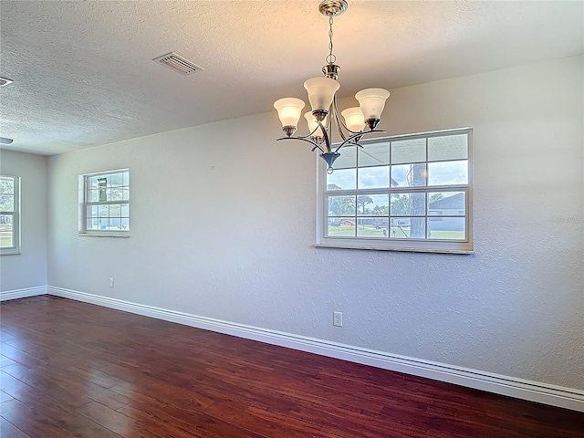 3045 Pine Tree Dr, Edgewater, FL 32141 - spare room with hardwood / wood-style floors, a chandelier, and a textured ceiling