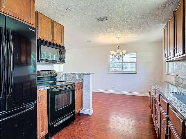 3045 Pine Tree Dr, Edgewater, FL 32141 - kitchen with black appliances, a chandelier, dark wood finished floors, a textured ceiling, and brown cabinets