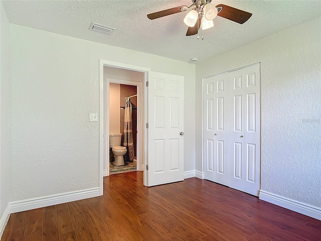 3045 Pine Tree Dr, Edgewater, FL 32141 - unfurnished bedroom with wood finished floors, a textured ceiling, a closet, a textured wall, and ceiling fan