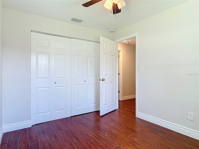 3045 Pine Tree Dr, Edgewater, FL 32141 - unfurnished bedroom with wood finished floors, a closet, a textured wall, and ceiling fan