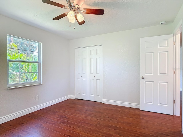 3045 Pine Tree Dr, Edgewater, FL 32141 - unfurnished bedroom featuring dark wood-type flooring, a closet, ceiling fan, and a textured ceiling