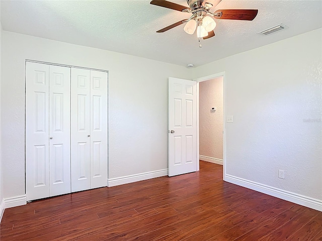 3045 Pine Tree Dr, Edgewater, FL 32141 - unfurnished bedroom featuring wood finished floors, a closet, ceiling fan, a textured ceiling, and a textured wall