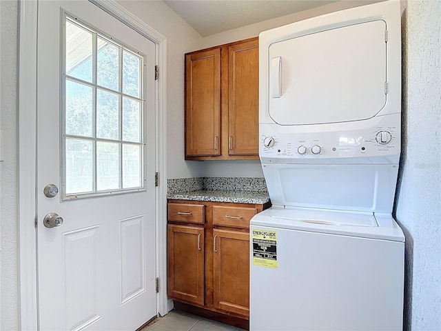 3045 Pine Tree Dr, Edgewater, FL 32141 - laundry room with stacked washing machine and dryer and cabinet space