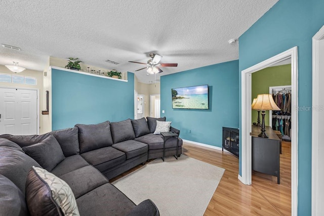 411 Ryans Ridge Ave, Eustis, FL 32726 - living area featuring light wood-style flooring, a ceiling fan, and a textured ceiling
