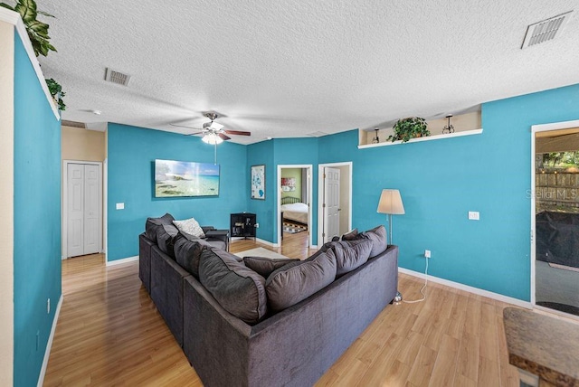 411 Ryans Ridge Ave, Eustis, FL 32726 - living room featuring light wood-type flooring, a textured ceiling, and ceiling fan