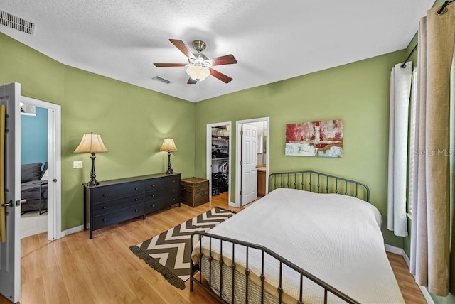 411 Ryans Ridge Ave, Eustis, FL 32726 - bedroom with light wood-type flooring, a walk in closet, ceiling fan, and a closet
