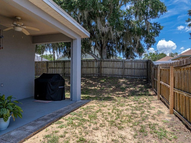 411 Ryans Ridge Ave, Eustis, FL 32726 - fenced backyard with ceiling fan and a patio