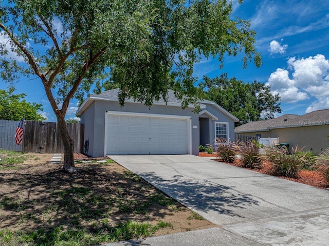 411 Ryans Ridge Ave, Eustis, FL 32726 - ranch-style home featuring a garage, stucco siding, and concrete driveway