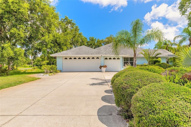 904 Clubhouse Blvd, New Smyrna Beach, FL 32168 - view of front of home featuring an attached garage, driveway, and stucco siding