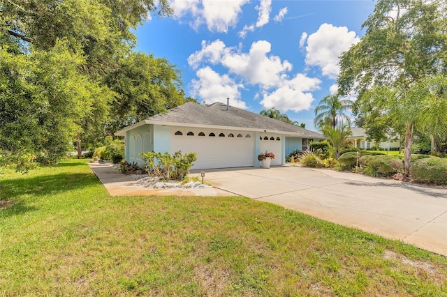 904 Clubhouse Blvd, New Smyrna Beach, FL 32168 - view of front facade with concrete driveway, a front yard, an attached garage, and stucco siding