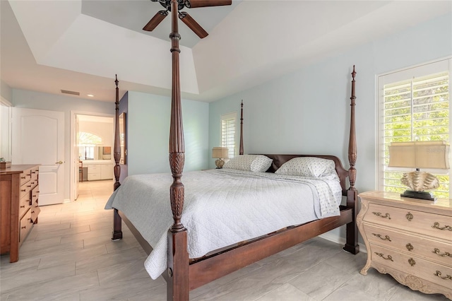 904 Clubhouse Blvd, New Smyrna Beach, FL 32168 - bedroom featuring a tray ceiling, multiple windows, ensuite bath, and ceiling fan