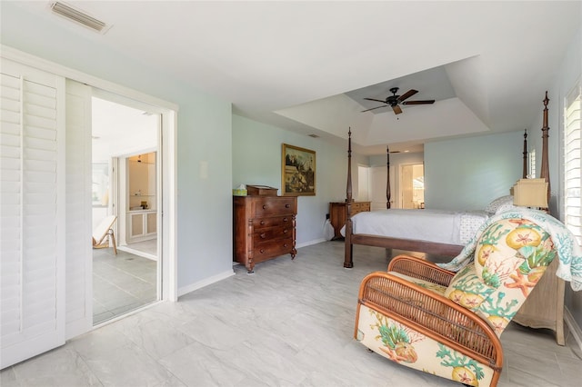 904 Clubhouse Blvd, New Smyrna Beach, FL 32168 - bedroom with a tray ceiling, a ceiling fan, and ensuite bathroom