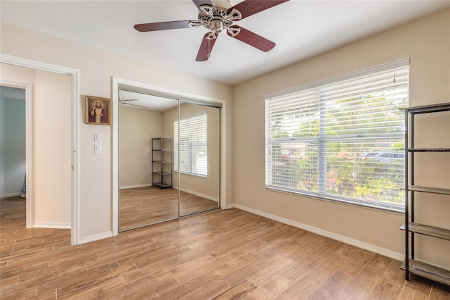 904 Clubhouse Blvd, New Smyrna Beach, FL 32168 - unfurnished bedroom with light wood-style floors, a closet, and a ceiling fan