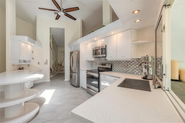 904 Clubhouse Blvd, New Smyrna Beach, FL 32168 - kitchen featuring appliances with stainless steel finishes, open shelves, white cabinets, ceiling fan, and high vaulted ceiling