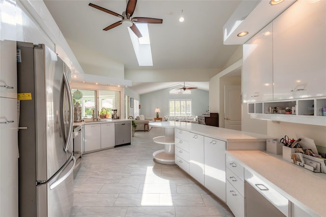 904 Clubhouse Blvd, New Smyrna Beach, FL 32168 - kitchen with appliances with stainless steel finishes, a ceiling fan, lofted ceiling, open floor plan, and light countertops