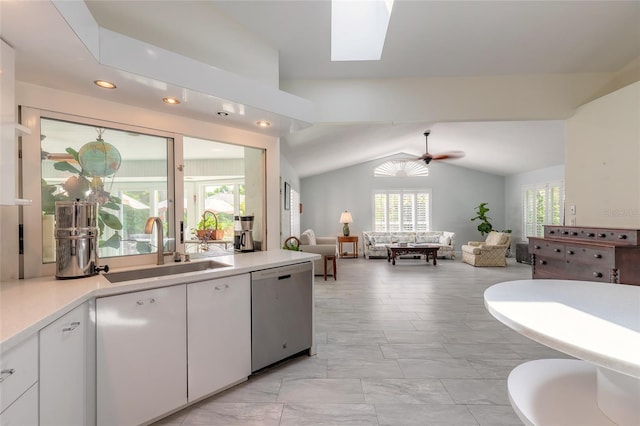 904 Clubhouse Blvd, New Smyrna Beach, FL 32168 - kitchen featuring dishwasher, vaulted ceiling, light countertops, white cabinetry, and recessed lighting