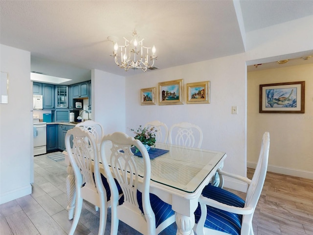 4175 S Atlantic Ave Unit 4110, New Smyrna Beach, FL 32169 - dining room featuring a chandelier and light wood-style flooring