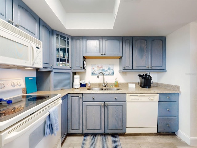 4175 S Atlantic Ave Unit 4110, New Smyrna Beach, FL 32169 - kitchen featuring white appliances, a tray ceiling, light countertops, and glass insert cabinets