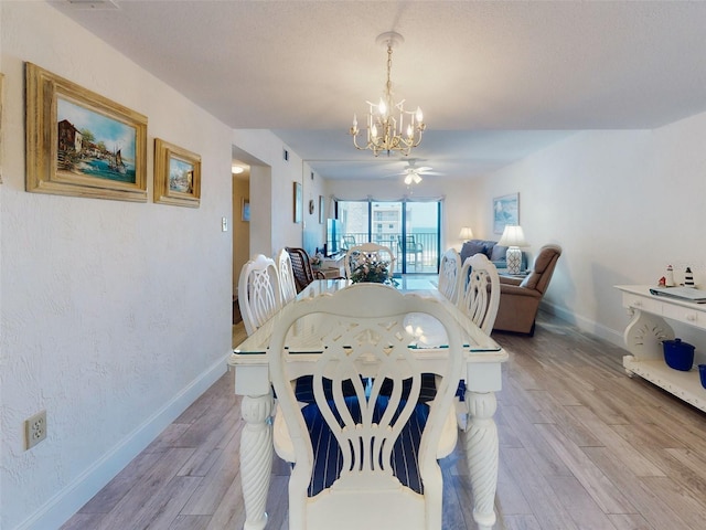 4175 S Atlantic Ave Unit 4110, New Smyrna Beach, FL 32169 - dining room with a chandelier, light wood-type flooring, and a ceiling fan