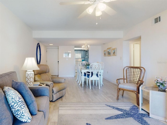 4175 S Atlantic Ave Unit 4110, New Smyrna Beach, FL 32169 - living area with light wood-style floors, a chandelier, and a ceiling fan