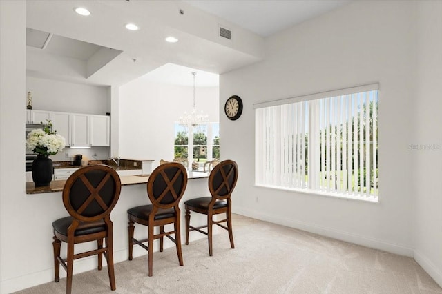 2 Oceans W Blvd Unit 206, Daytona Beach Shores, FL 32118 - dining area with a chandelier, recessed lighting, and light carpet